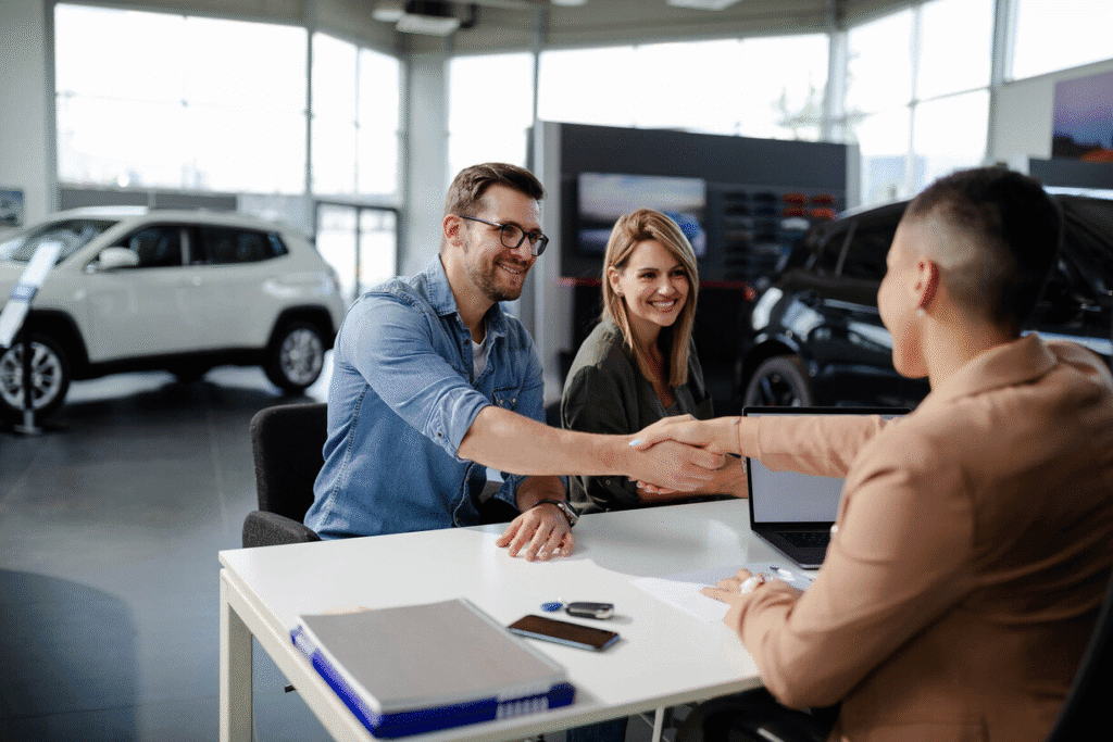 Customers discussing a car purchase with a Black Wheel Motors advisor inside the showroom